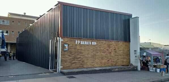 Commercial building clad in dark vertical metal sheeting above a face-brick facade on Berea Road