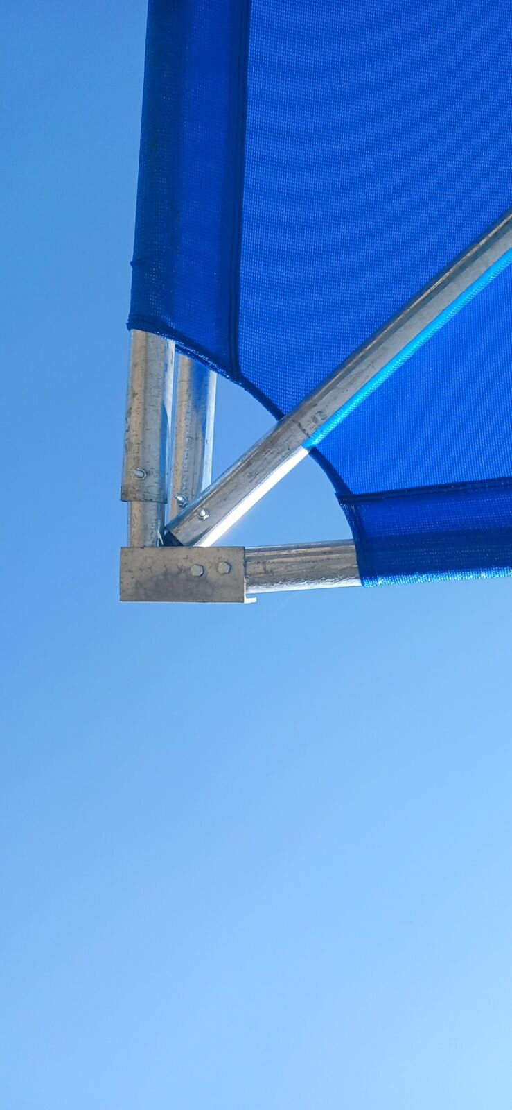 Underside view of a galvanised shadeport frame showing the bolted bracket where two braces meet the column